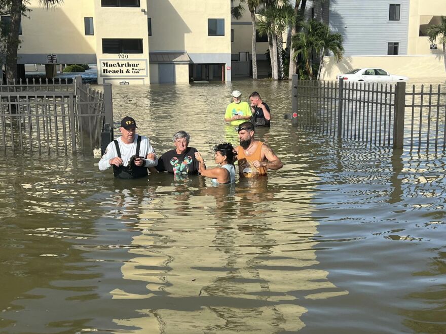 Rescue crews assist residents after conducting door-to-door wellness checks, in coastal areas that were flooded by Hurricane Helene on Friday, Sept. 27, 2024 in Venice.