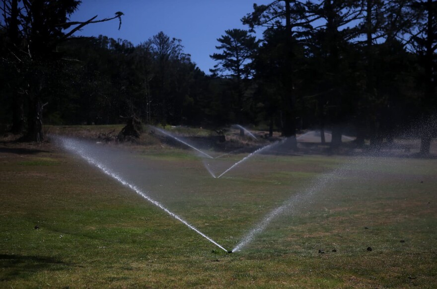 Sprinklers water grass on a fairway at a golf course in San Francisco. (Justin Sullivan/Getty Images)