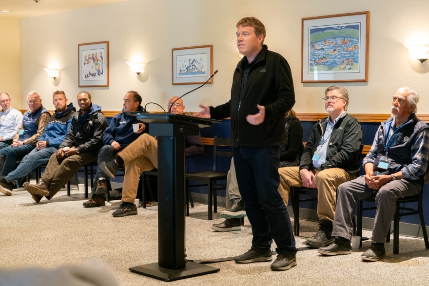 Representatives look on as Alaska DOT Commissioner Ryan Anderson addresses the crowd.