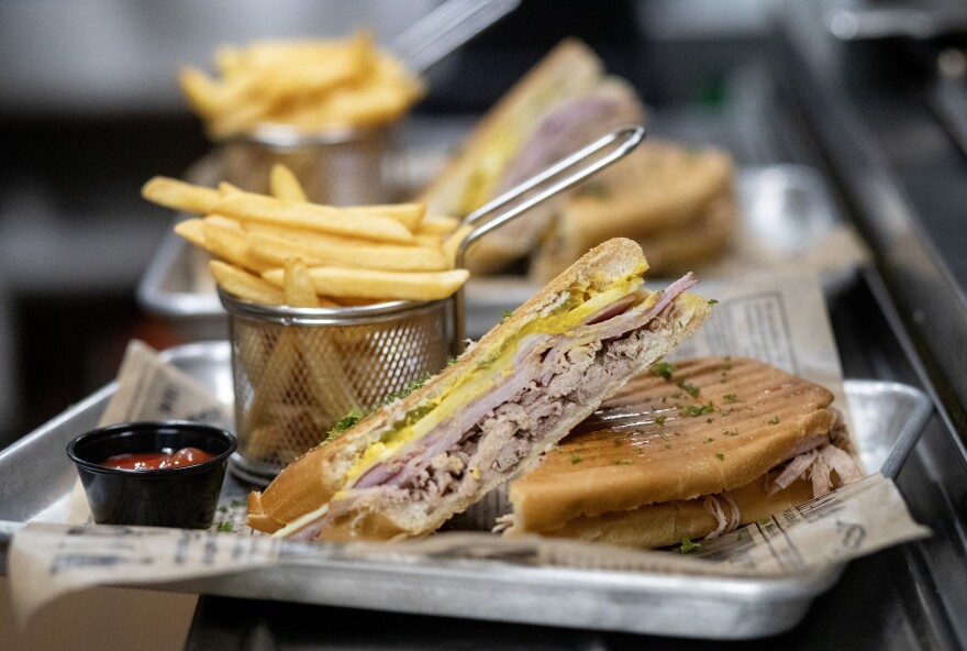 Cubans Be Like restaurant makes a Miami-style cuban sandwich with Cuban bread, roasted pork, Serrano ham, pickles and mustard.