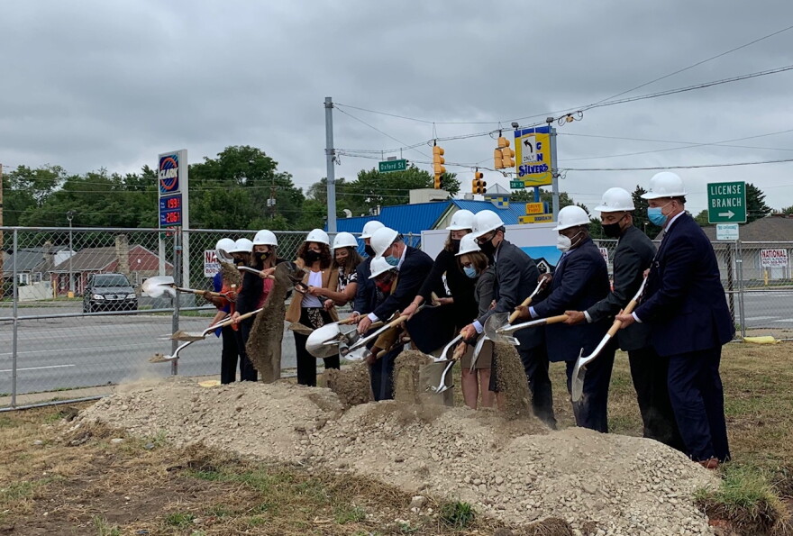Representatives of First Merchants Banks and Indianapolis officials break ground for a new bank branch on the city's near northeast side.
