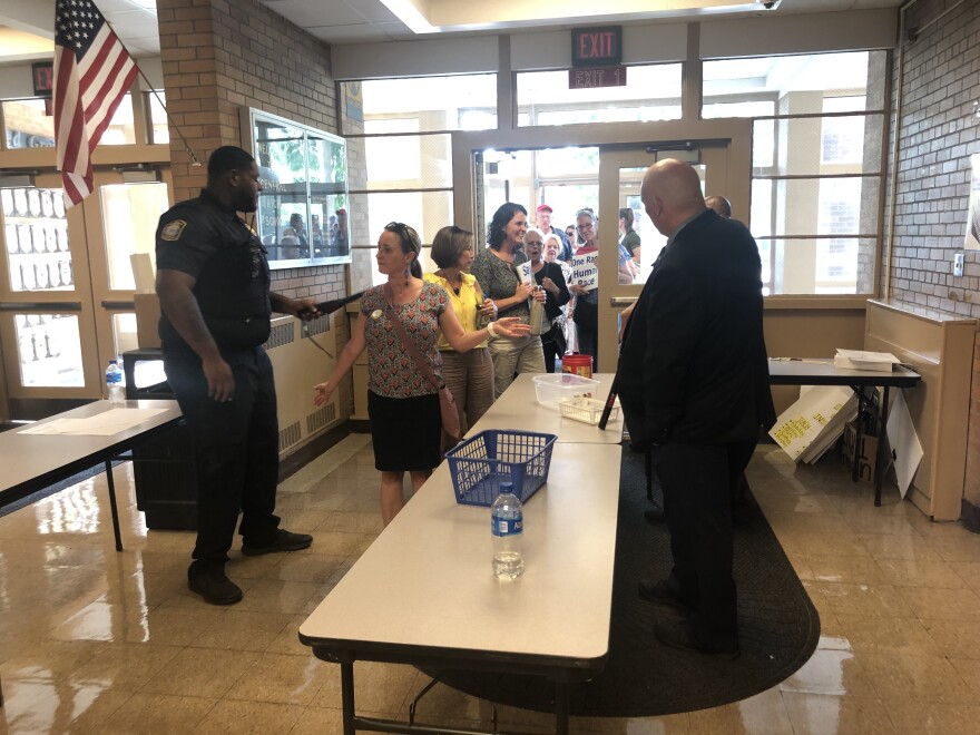 Dozens of protesters came to the July JCBE meeting to oppose a mask mandate. Members of the JCPS's Security and Investigations Unit scanned people for weapons as they entered, part of the district's heightened security measures after a man opposed to masks allegedly threatened JCPS superintendent Marty Pollio.