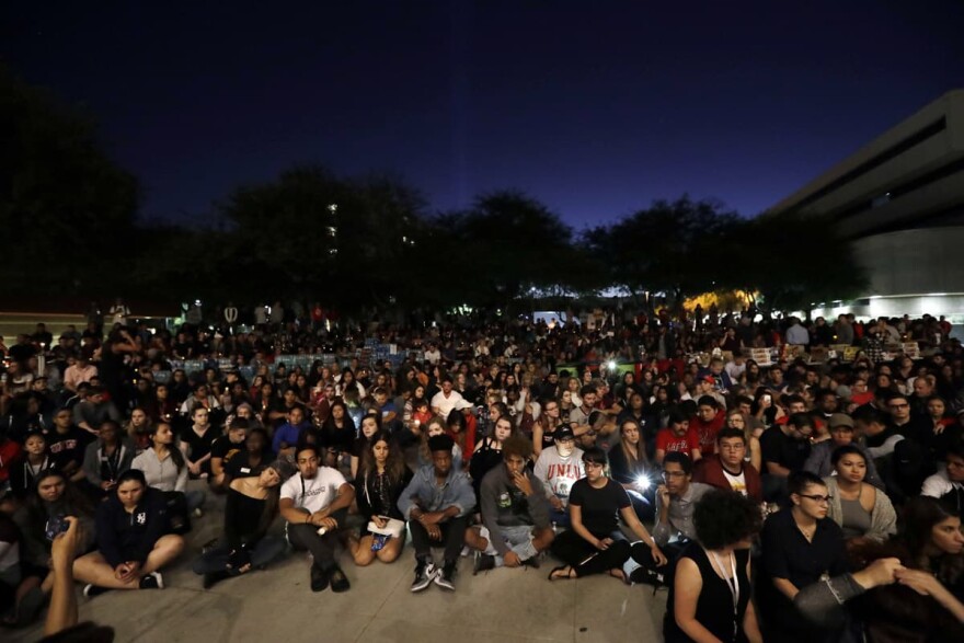 Students from University of Nevada Las Vegas hold a vigil Monday, Oct. 2, 2017, in Las Vegas. A gunman on the 32nd floor of the Mandalay Bay casino hotel rained automatic weapons fire down on the crowd of over 22,000 at an outdoor country music festival Sunday. (AP Photo/Gregory Bull)