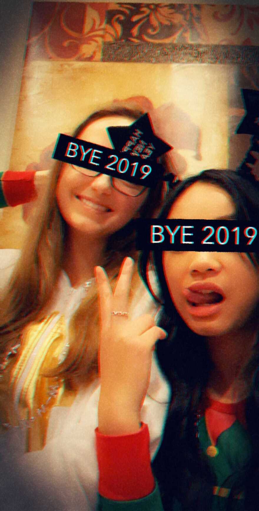 Avery Thunder and Janelle Olisea are posing for a selfie. Black bars that say "BYE 2019" are covering both of their eyes.