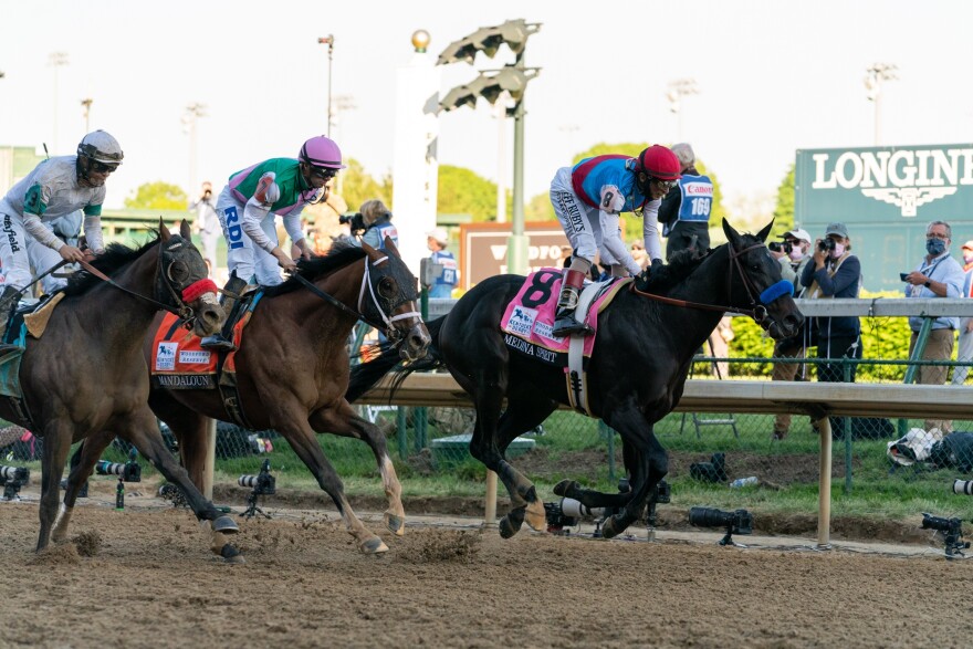 Horses race on the track at Churchill Downs.