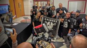 Raiders fans flank Napoleon McCallum, a former running back for the team and current Las Vegas Sands executive, during a break from the Southern Nevada Tourism Infrastructure Committee meeting to discuss a new stadium that might lure the team to Las Vegas. Local Raiders Nation board member Big John Baietti, top right, said having NFL and UNLV football and Major League Soccer playing under the new stadium’s dome would be a “trifecta of awesomeness.”