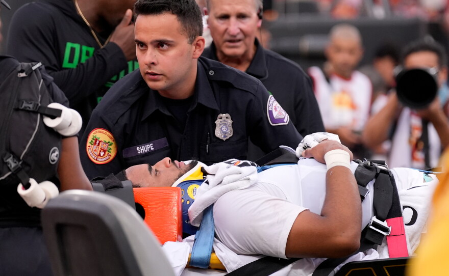 Oregon quarterback Dante Moore, bottom, is loaded into an ambulance following a hard tackle by Southern California linebacker Desman Stephens II during the first half of an NCAA college football game, Saturday, Sept. 26, 2026, in Los Angeles.