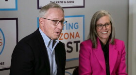 Arizona Democratic Gov. Katie Hobbs, right, smiles as she listens to her running mate for Lieutenant Governor John Giles, the former Republican Mesa, Ariz., mayor, answer a question, Monday, Aug. 10, 2026, in Phoenix. (AP Photo/Ross D. Franklin)