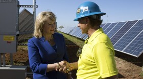 Mary Fallin meets with a worker at a July 2015 event commemorating Oklahoma Gas & Electric's new solar farm in Oklahoma City.