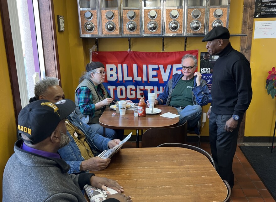 Larry Stitts chats with customers at Golden Cup Coffee Company, Jefferson Ave. at E. Utica Ave.
