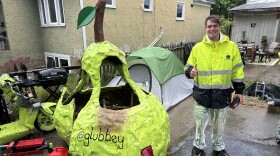 24-year-old sculpture artist Andrew Glubbey smiles next to his magnum opus, "Pear Car." He stopped in Missoula for a week in late June to swap the broken scooter beneath the pear for a more powerful touring motorcycle.