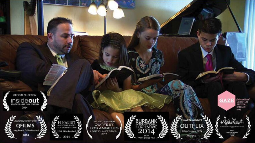 Photo of a family of four, reading scriptures together. The film won several awards, some of which are noted on the photo.