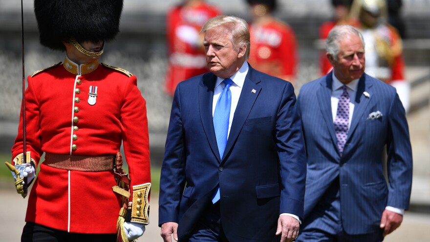 President Trump (center) inspects an honor guard with Prince Charles on Monday after arriving at Buckingham Palace in London.