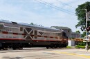 An image of an Amtrak Passenger rail engine at a crossing in Uptown Normal