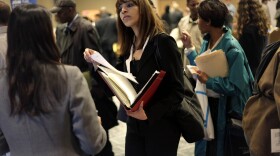 A woman at a job fair in New York talks to an employer. (Seth Wenig, File/AP)
