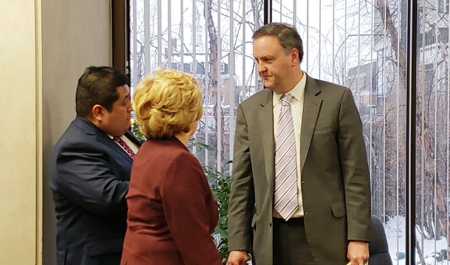 St. Louis County Councilman Sam Page, a member of the council's ethics committee, talks to St. Louis County Economic Development Partnership board members Karlos Ramirez, left and Kathy Osborn, center, after the two testified to the committee on Jan. 15, 