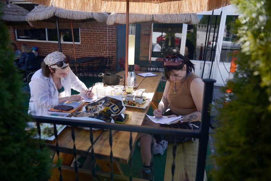 Kelaiah Killmade, left, and Claire Eile, right, eat dinner and draw in coloring books on Wednesday, May 3, 2023, at El Oso Mexican Grill in Columbia. Eiler said she and Kill are “good buds” and have been friends for more than a year. 
