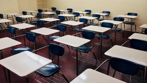 Vacant desks inside an empty classroom.