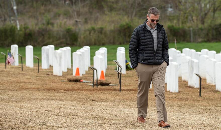 Lonon faces away from the cemetery while walking away.