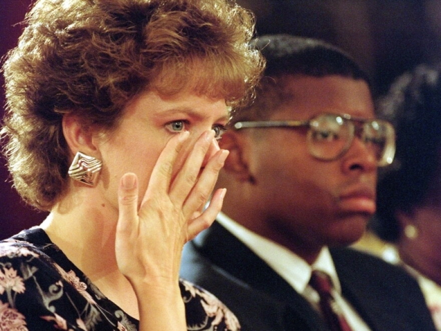 Virginia Thomas, wife of then-Supreme Court nominee Clarence Thomas, wipes away a tear during her husband's 1991 confirmation hearings. Thomas was accused of sexual harassment by former aide Anita Hill.