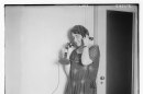 vintage photo from 1900 of a woman answering a phone