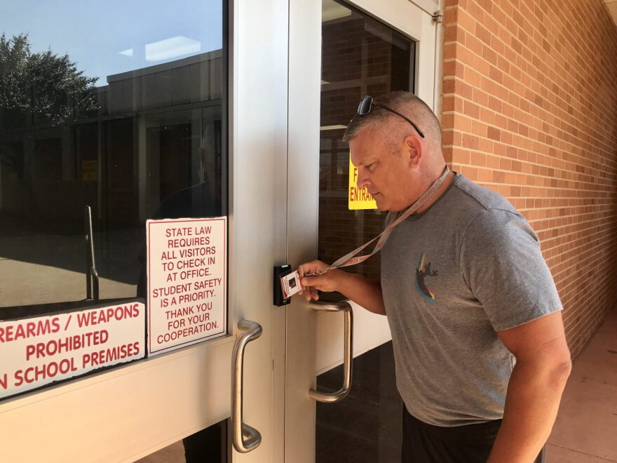 Moore Public Schools Superintendent Robert Romines demonstrates the district’s new building entry system.