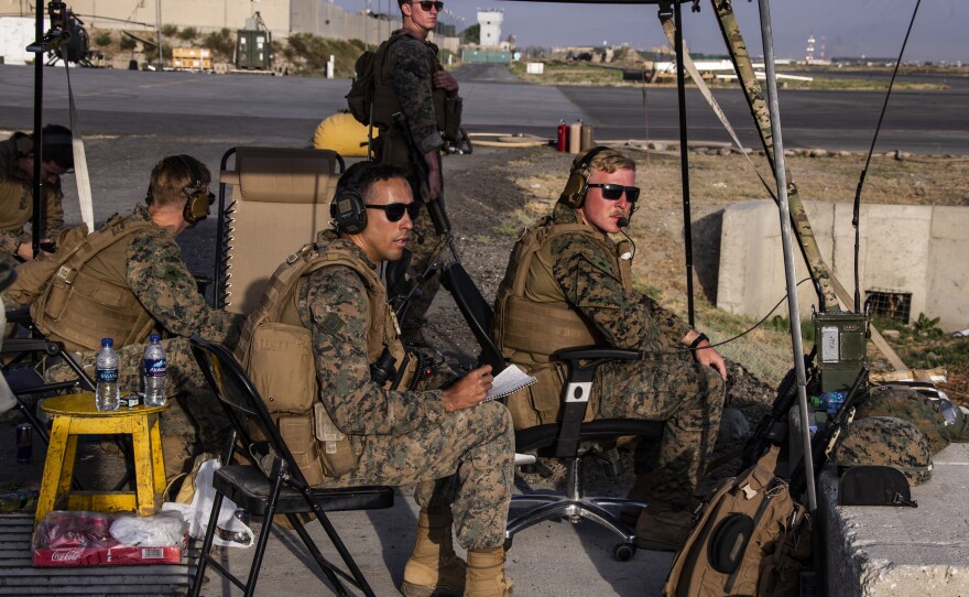 In this image provided by the U.S. Marine Corps, Marines assigned to the 24th Marine Expeditionary Unit monitor the air traffic control center at Hamid Karzai International Airport in Kabul, Afghanistan on Sunday, Aug. 22, 2021.