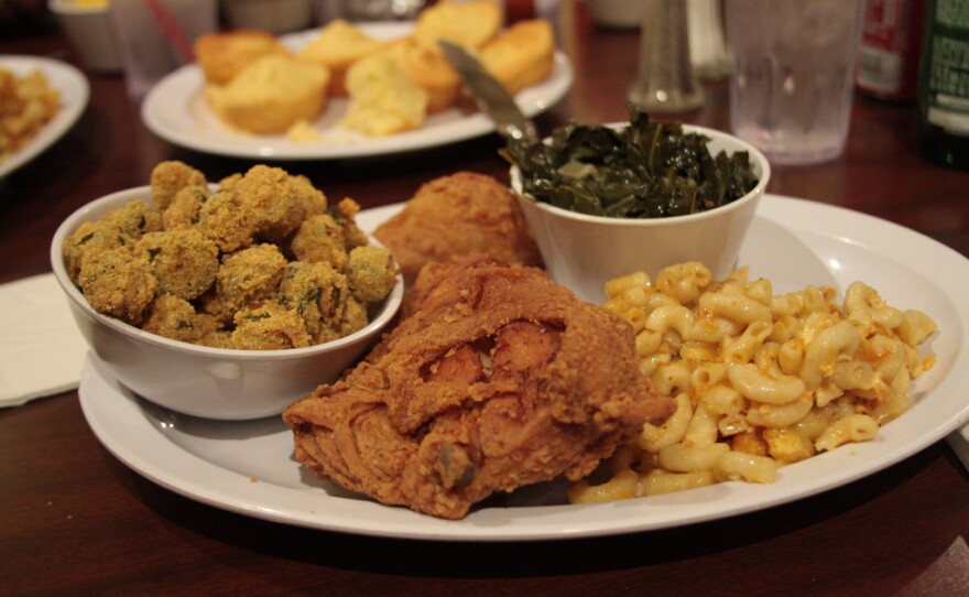 Image of a plate of soul food, including fried chicken, mac and cheese, collards, and fried okra.