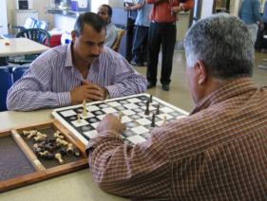 Taxi drivers play chess in the facility while they wait for their numbers to be called.