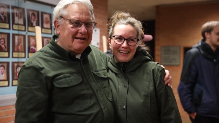 Brainerd Dispatch photographer Steve Kohls poses for a photo with KAXE News Director Chelsey Perkins in February 2023 after a Rosenmeier Forum highlighting his news photography at Central Lakes College.