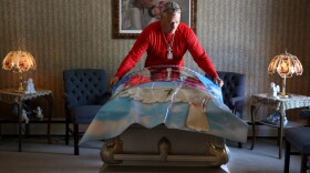 Richard Collinge wraps a casket for a family who's son died the day before the funeral at Angel Hills Funeral Chapel in Rochester.