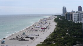 Beach chairs and umbrellas line the beach, Monday, Nov. 15, 2021, in Miami Beach. As the tourism industry struggles to bounce back from COVID-19, and eager but tentative travelers resume plans, Miami is one of the top search destinations on several travel websites. (AP Photo/Lynne Sladky)