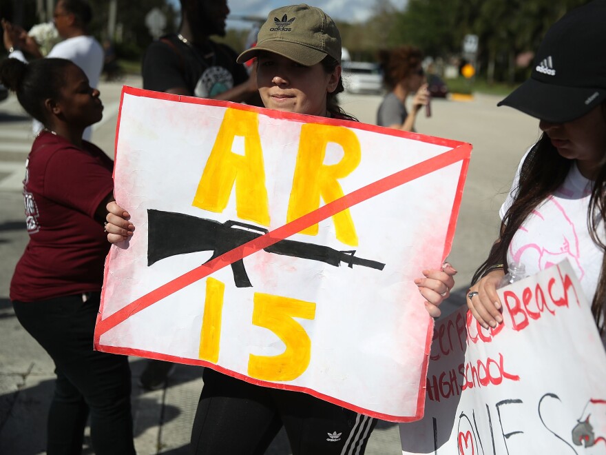 Deerfield Beach high school students arrive at Marjory Stoneman Douglas High School on Friday after walking 11 miles from school to school in support of the victims of the mass shooting in Parkland, Fla.