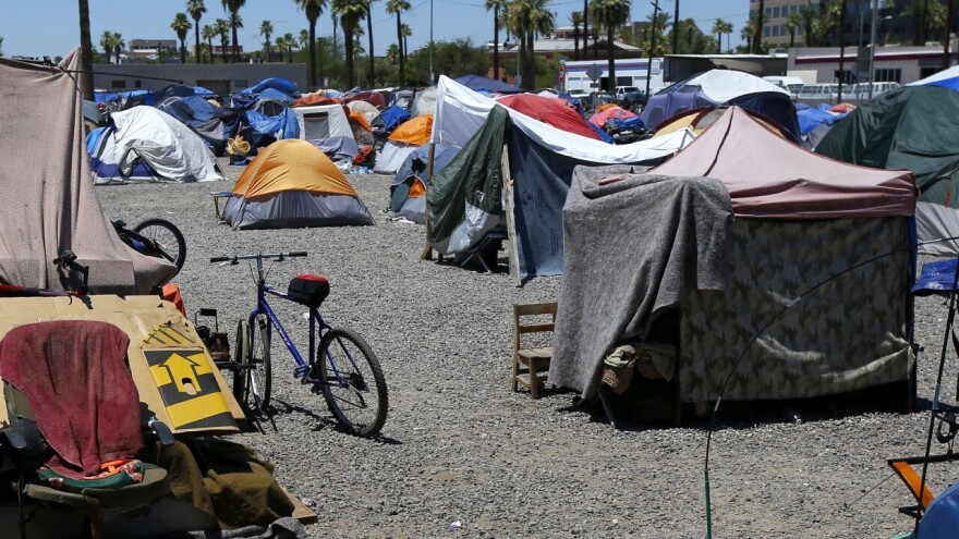 A large homeless encampment is shown Wednesday, Aug. 5, 2020, in Phoenix. Maricopa County officials said Wednesday there have been 490 cases of homeless people infected with the virus since the pandemic began among the county's approximately 7,400 homeless, with at least nine people self-identifying as homeless have died in Maricopa County.