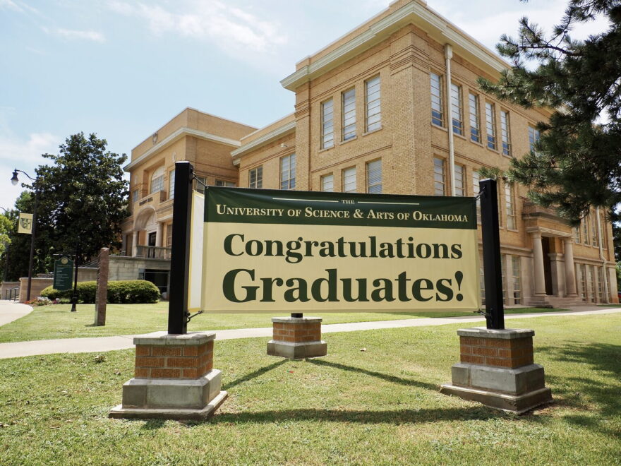 A sign outside of Troutt Hall on the University of Science and Arts of Oklahoma campus congratulates graduates on July 10, 2024, in Chickasha.