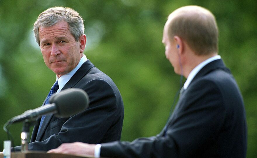 President George W. Bush glances at Russian President Vladimir Putin during their joint press conference on June 16, 2001, in Slovenia.