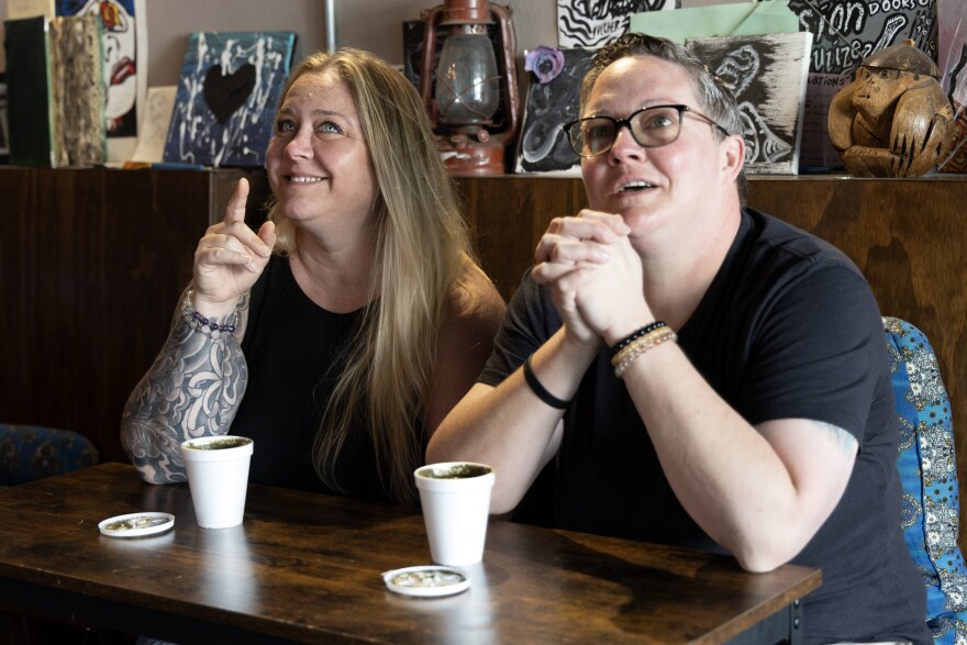 Heather Casey and Erin Hart sit together with cups of kava. The two enjoy the relaxing feeling of the beverage while still being able to carry out their day. (Delia Rose Sauer/WUFT News)