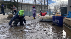 Preschoolers play in the snowmelt at Hillcrest Children’s Center in Anchorage on April 18, 2024. 