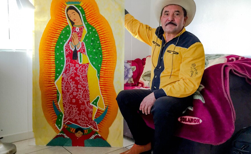 Francisco Hernandez poses with his beaded Virgin of Guadalupe in his White Center apartment