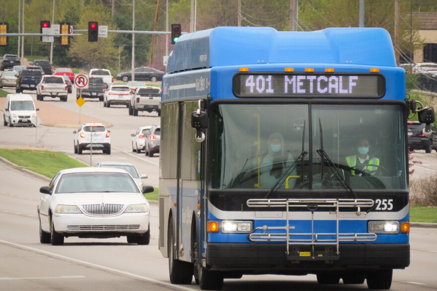 People board a blue RideKC bus in Kansas City.