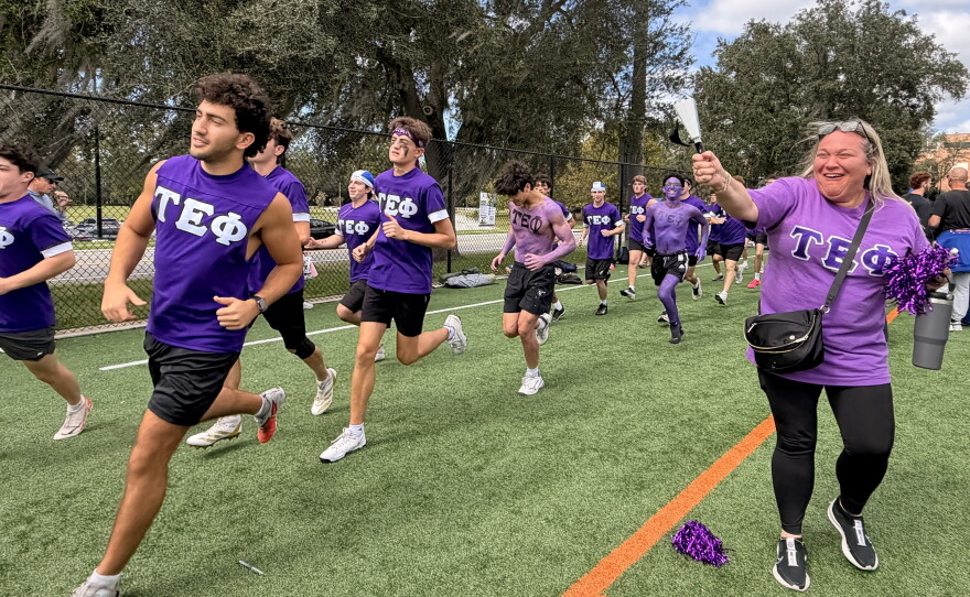 Members of Eli Silverman’s fraternity, Tau Epsilon Phi, running on the sidelines Sunday, Oct. 18, 2026. (Madison Middleton/WUFT News)