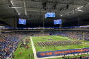 First responders treat an injured service member following a fall at the Alamodome Saturday.