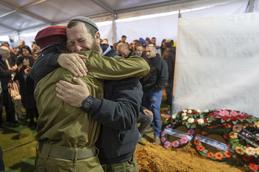 Mourners attend the funeral of reservist Gavriel Shani during his funeral at Mount Herzl military cemetery in Jerusalem on Wednesday, Jan. 31.