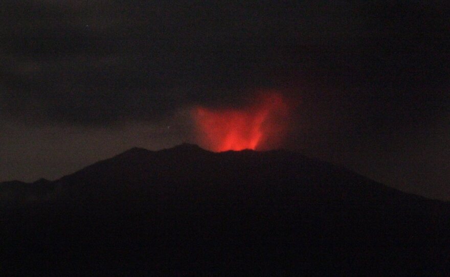 Mount Raung spews volcanic materials as seen from Sumber Arum village in Banyuwangi, East Java, Indonesia, on Friday.
