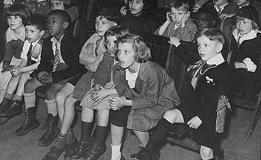 New York City children attend a show by the Marionette Unit of the WPA's Federal Theatre Project puppet show in 1935.