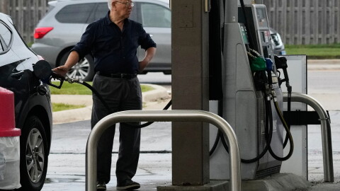 A customer checks gas price while he fills up his vehicle's tank at a gas station, Wednesday, Sept. 16, 2026.