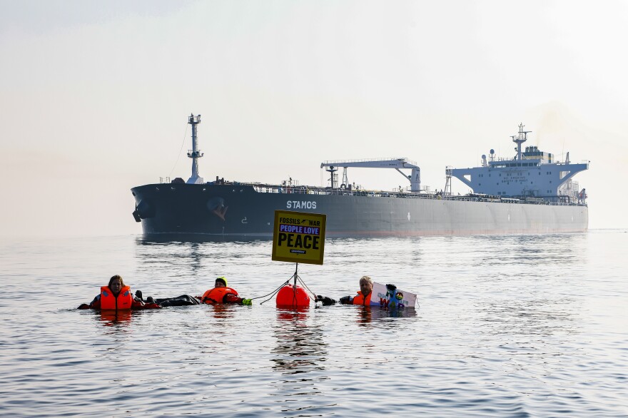 Activists demonstrate in front of a ship carrying Russian oil in the Baltic Sea this spring. The U.S. has imposed sanctions on Russian oil. However, most countries have not, and refineries around the world still import Russian oil.