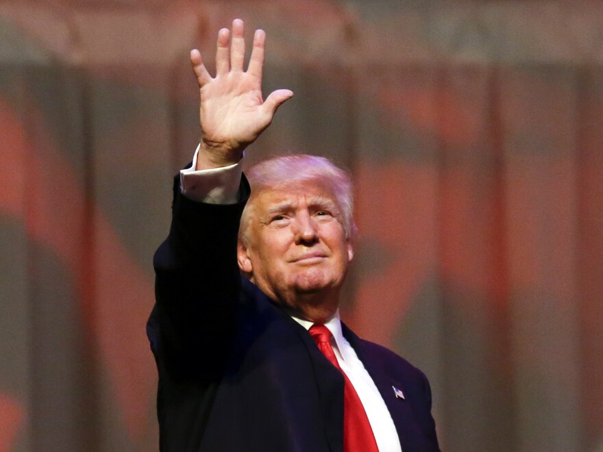 Republican front-runner Donald Trump waves at a rally in Carmel, Ind.