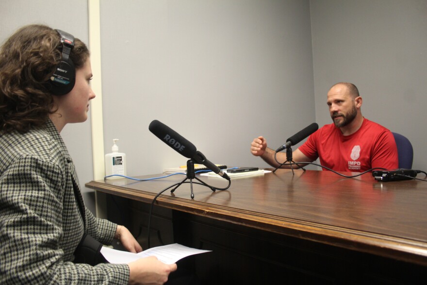 WFYI criminal justice reporter interviews IMPD Officer Damon Young on Dec. 11, 2023.