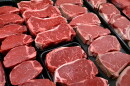 Rows of raw steak in a deli cabinet.